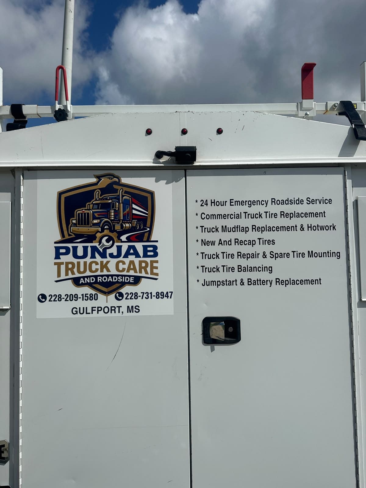 Rear of Punjab Truck Care and Roadside service van with services and phone numbers